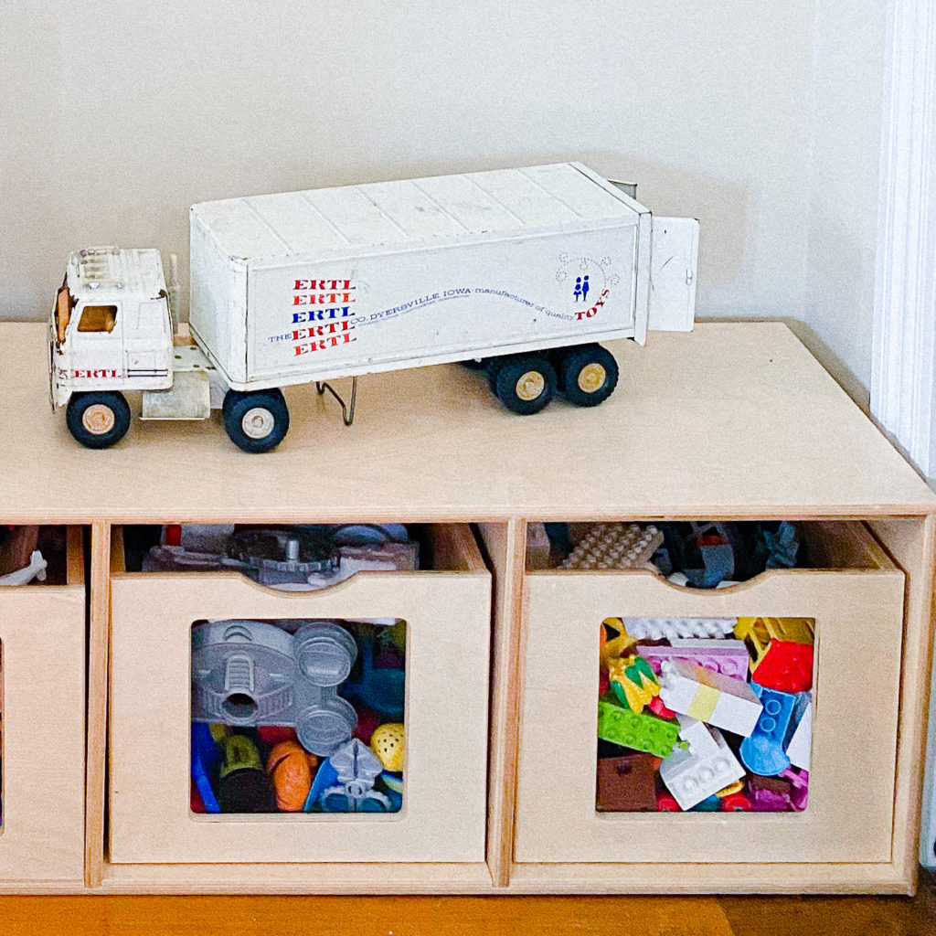 Cubbies for toy storage with a truck on them