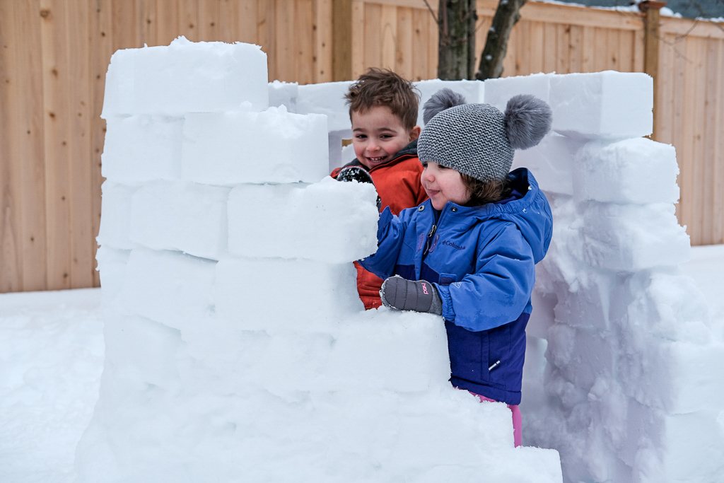 Kids building snow igloos with molds
